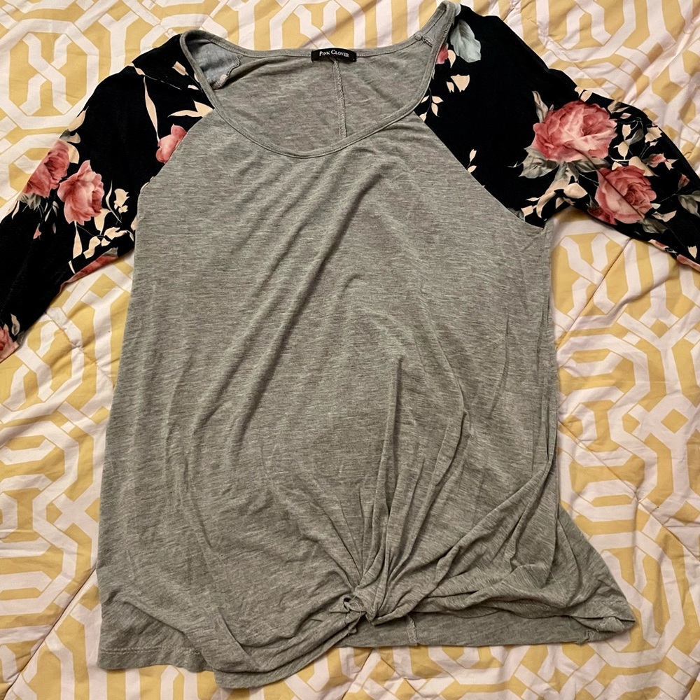 Grey 3/4 sleeved top with navy blue and flowers on the sleeves.